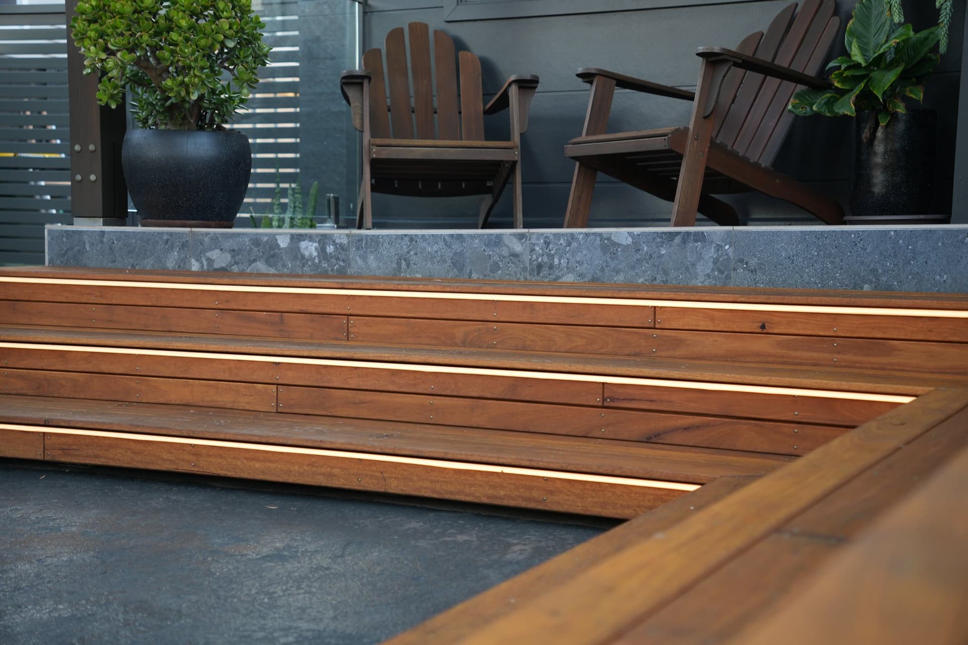 Hardwood deck at dusk with mitred steps and recessed strip lighting, built by JTR Built