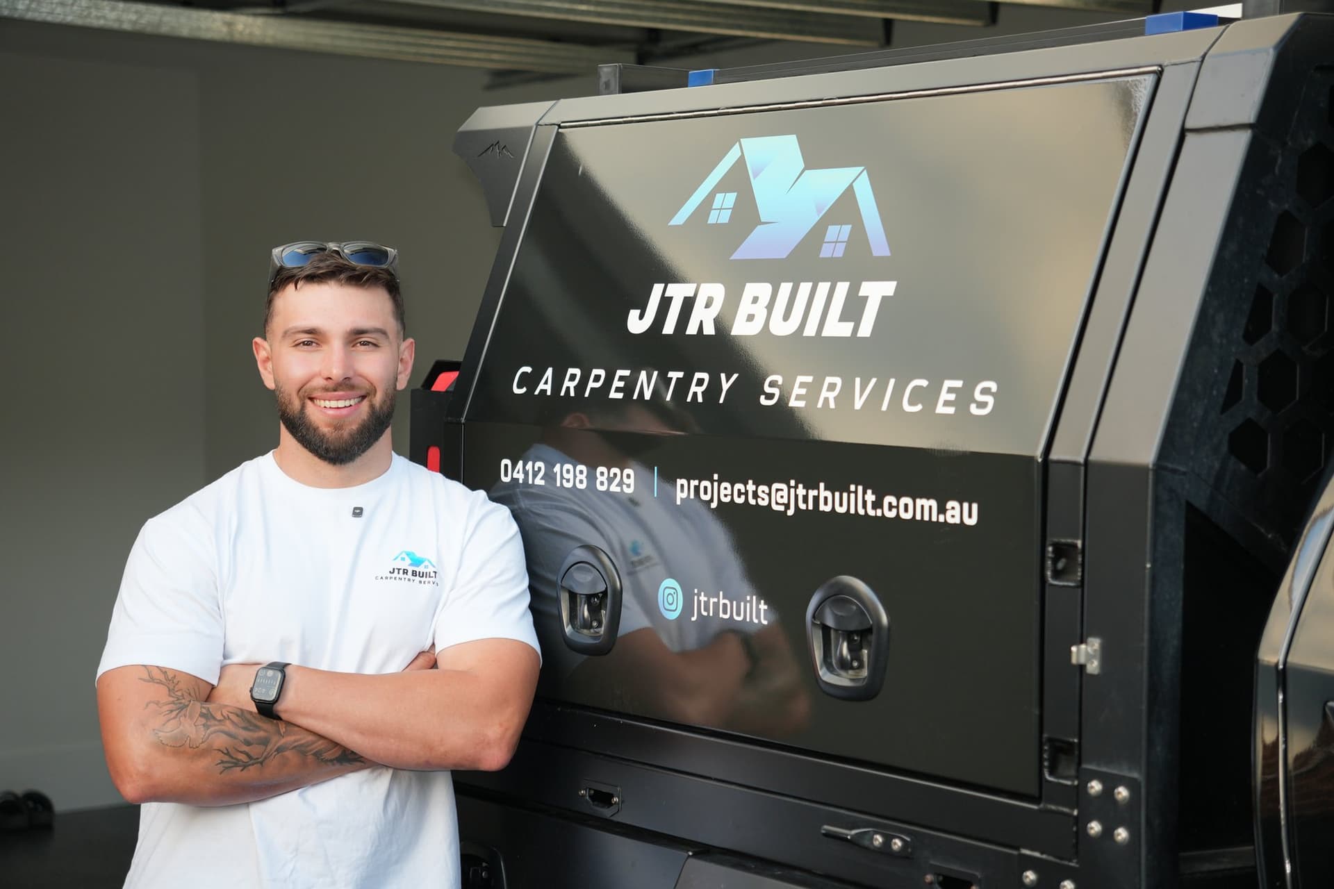 James Russo beside the JTR Built ute canopy, business signage behind him