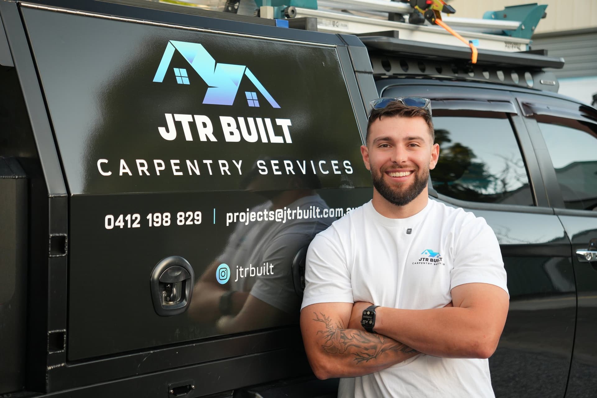 James Russo beside the JTR Built ute canopy with the business signage