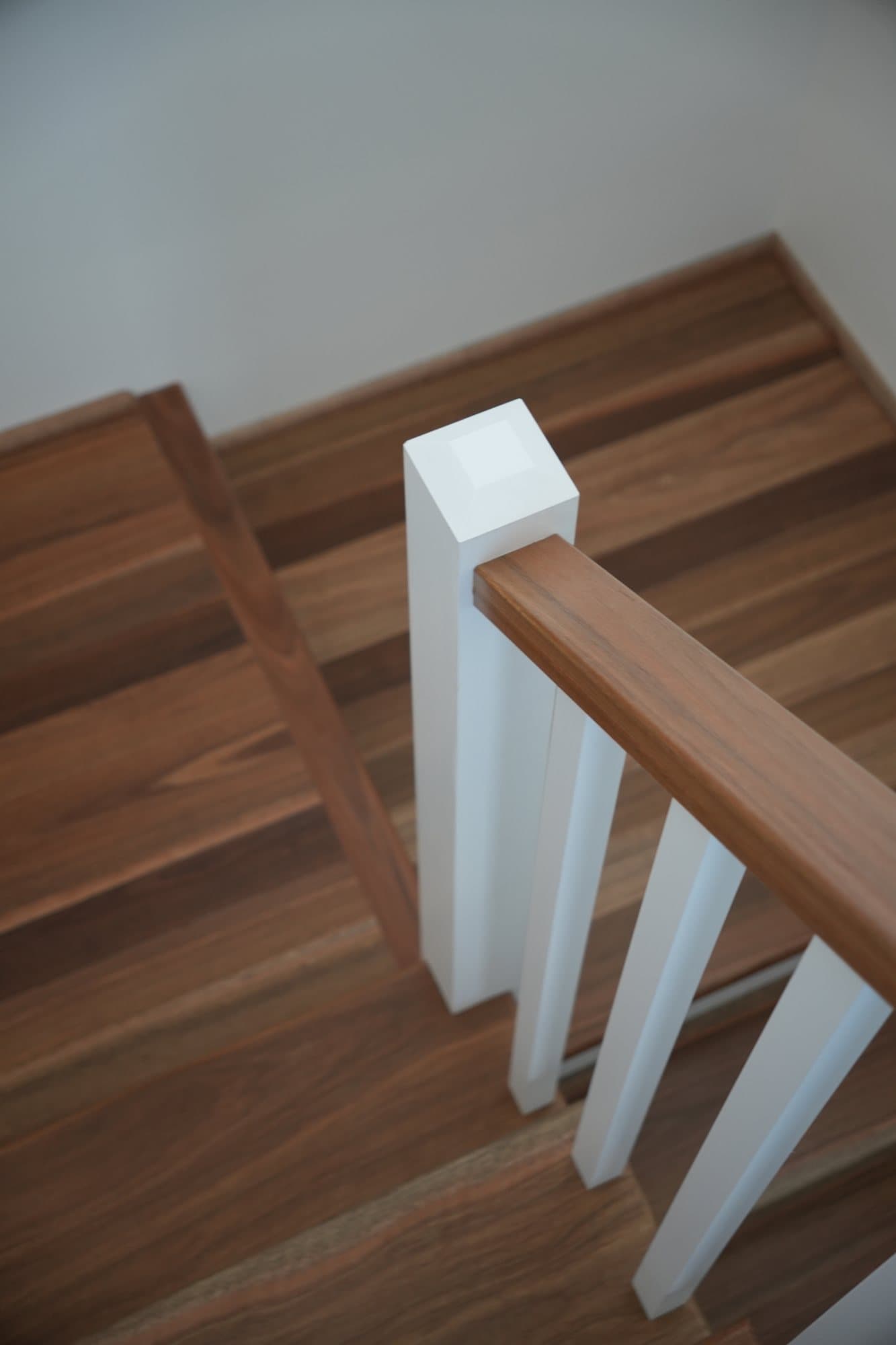 Hardwood handrail meeting the newel post — detail carpentry by JTR Built